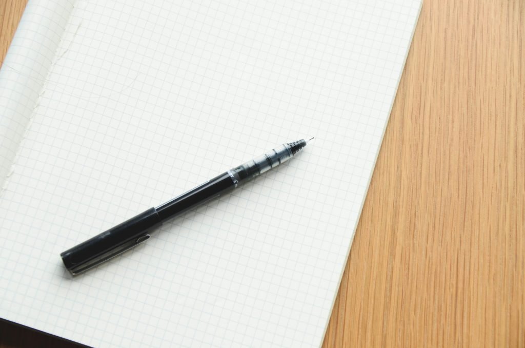 Dog CBC values chart notes in an open grid notebook with a black pen.