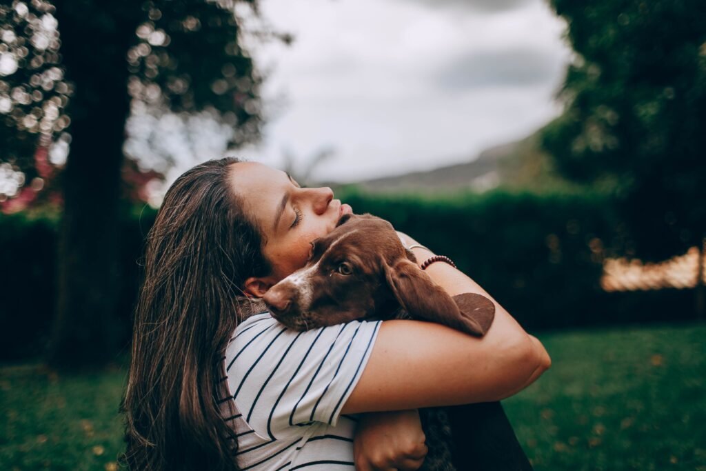 Owner hugging her dog, reflecting the bond dogs form with their owners