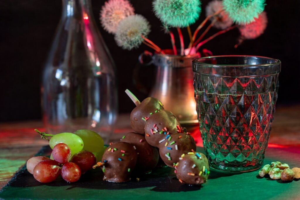 Chocolate and grapes on a table, both foods toxic to dogs